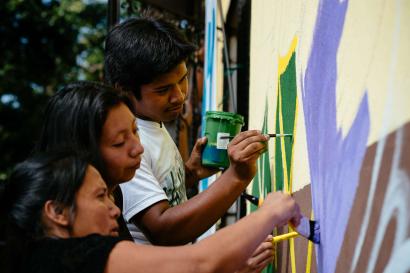 A group of people painting.