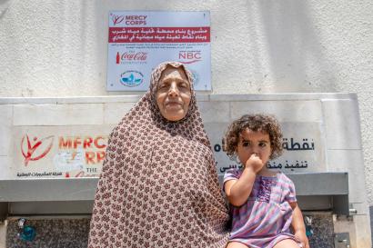 A grandmother and her granddaughter at a mercy corps water point in southern gaza in 2019, built by mercy corps.
