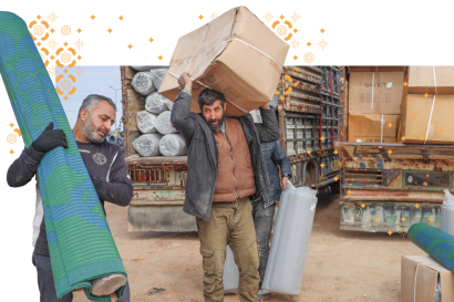 Syrian men unload goods from a truck.