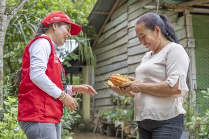 Mercy corps employee and colombian participant interact outside.
