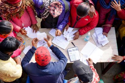 View from above of individuals at a cash distribution point.