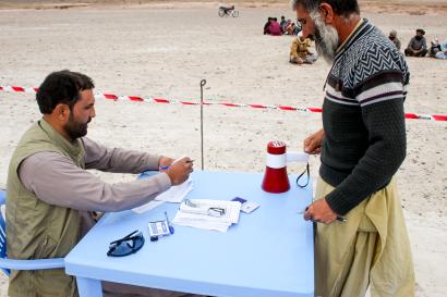 Man receives cash assistance at a distribution event