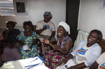 Noella pictured laughing with a group of women seated next to each other