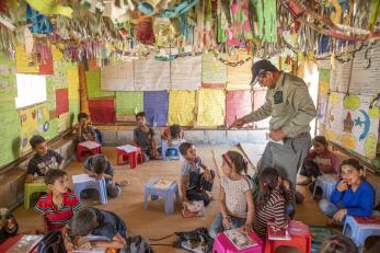 Ahmed teaching a group of children in the school