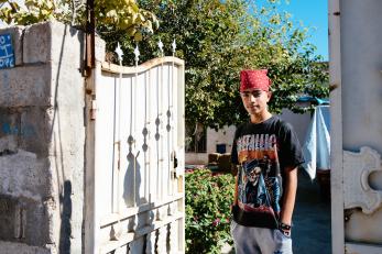 Sepan standing next to an open gate