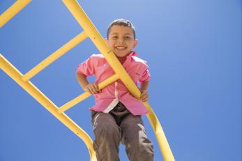 Yazan playing on yellow monkey bars