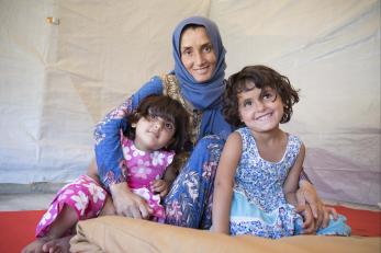 Mother with young daughters smiling in lebanon