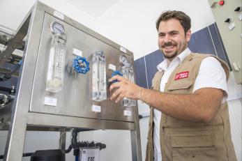 Mahmoud next to an improved water filtration system