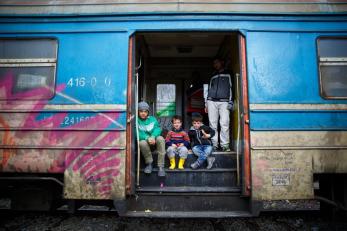 A group of young boys board a train in presevo, serbia that will take them to their next stop on the refugee route.
