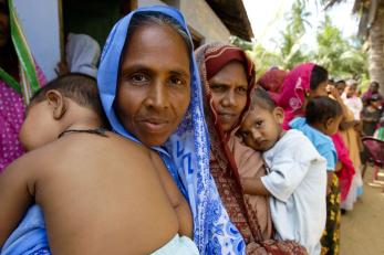 Women holding small children