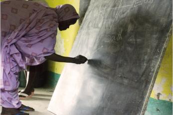 Woman writing on chalkboard