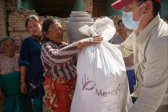 A woman receives a bag of materials