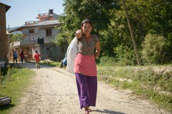 Woman carrying bag of supplies