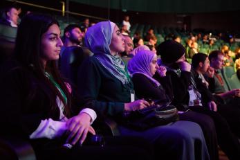 People seated in an auditorium.