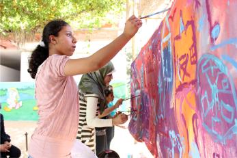 A girl painting a mural