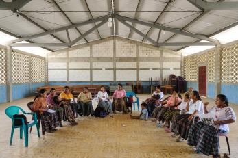 Women seated in chairs gathered in a horseshoe shape