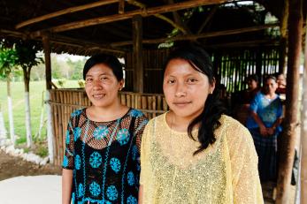 Two women standing side by side, smiling