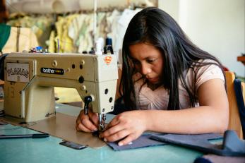 Olga working at a sewing machine