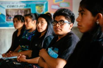 Youth in a savings and loan group meeting