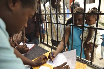 People receiving payment for their rebuilding work