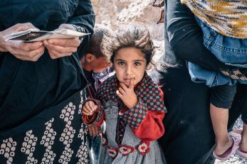 A small girl looking up at the camera