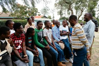 A group of people smiling and talking to one another