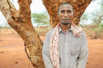 Musa standing in front of a tree