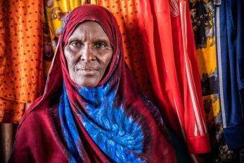 Salada portrait with colorful fabric draped behind her