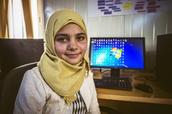 Azeh in front of a computer monitor