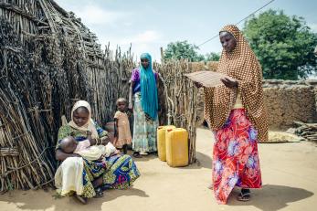 Balkissa visiting with a family in her village