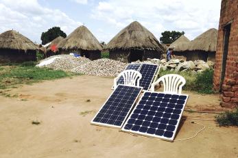 Solar panels outside homes in uganda