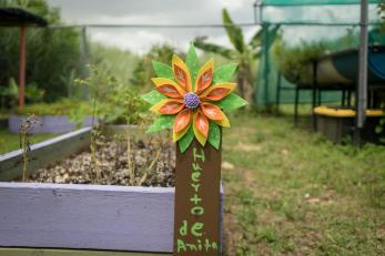A decorative flower sign in the community garden