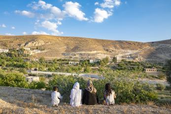 Farat and her daughters looking out at the landscape