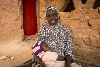 Fati holding a young girl.