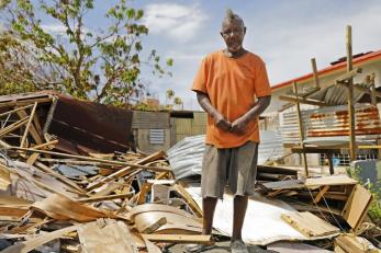 Luis standing in front of debris