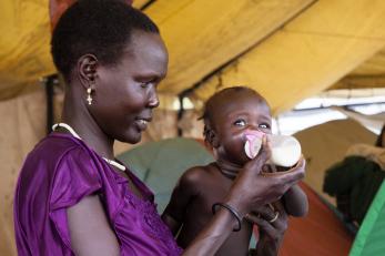 Woman feeding a baby from a bottle