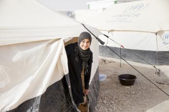 Nour leaves her tent in the refugee camp