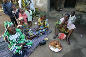 A group of people gathered near a plate of food in car
