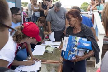 Mercy corps team members provide materials, including water filters, to help people in puerto rico