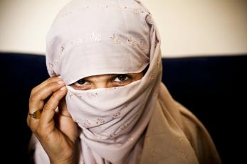 A woman who teaches in a mercy corps program in afghanistan wearing a pink veil