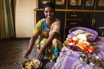 A woman in ethiopia prepares to serve a meal