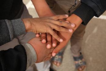 Hands overlapping at za'atari refugee camp in jordan