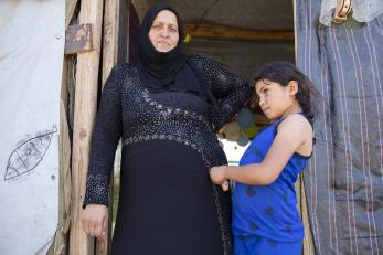 Woman and child standing in doorway.