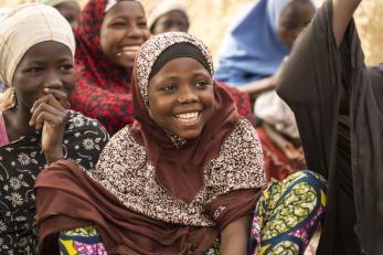 Girls smiling and laughing at a girls' safe space in niger