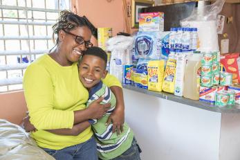 A woman embraces her son in puerto rico. both are smiling.