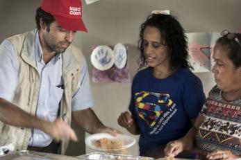 A mercy corps team member serves food in puerto rico