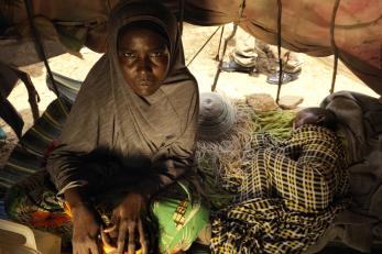 A woman in somalia with her child sleeping next to her
