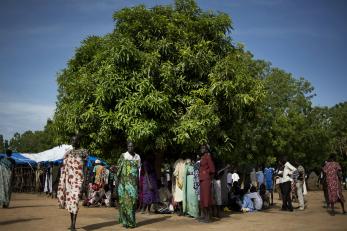 Image: early morning in ganyiel and people seeking shelter from the sun.