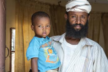 Wassim holding his 2-year-old son