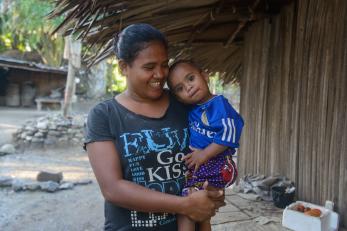A woman holding her young daughter in timor leste